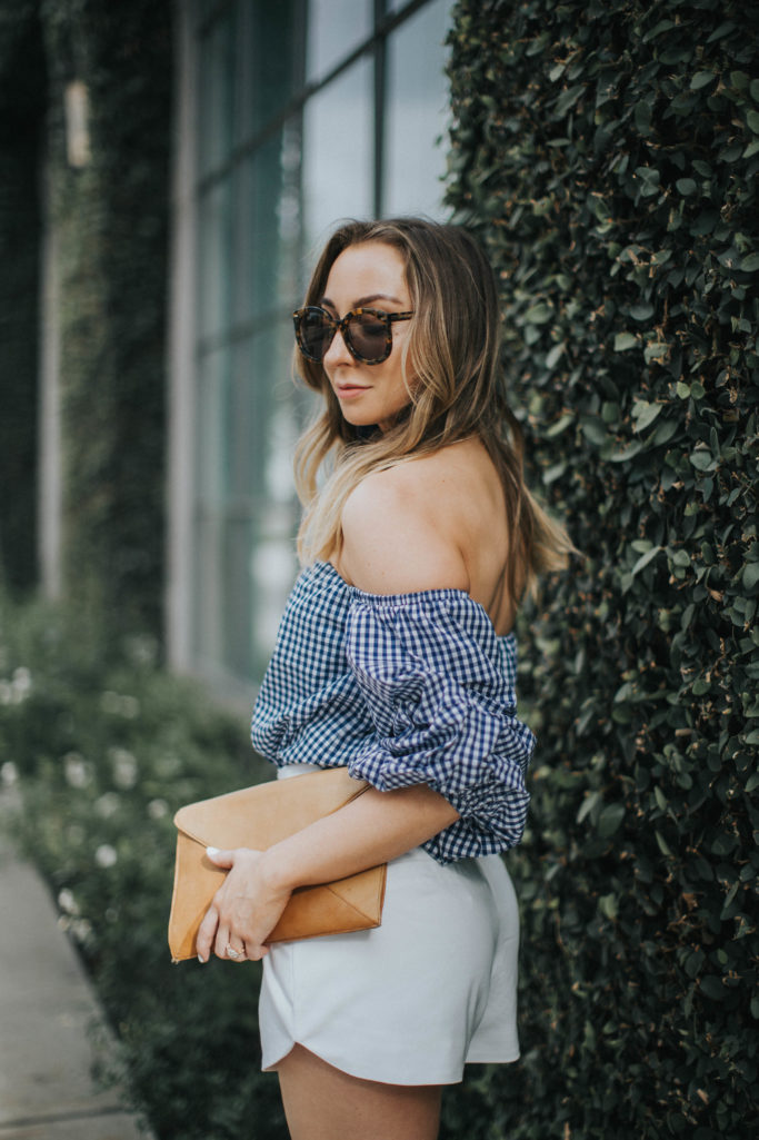 Spring Outfit : Blue gingham off the shoulder top, white shorts, tan clutch